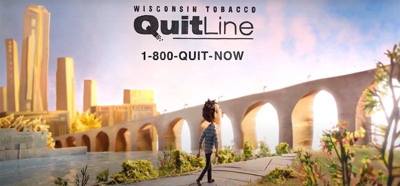 Quit Line commercial featuring a person walking along the waterfront in the foreground with a bridge and city skyline in the background